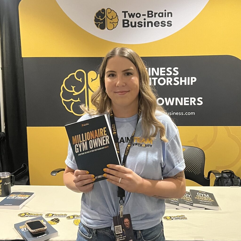 Pictured: Me with one of the books I've edited—Millionaire Gym Owner by Chris Cooper, founder and CEO of Two-Brain Business—at Two-Brain's annual Summit in Chicago in June 2024